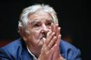 Uruguay's President Jose Mujica looks up during a press conference at the workers union PIT-CNT in Montevideo, Uruguay, Tuesday, Dec. 16, 2014. Mujica says the United States has guaranteed that six former Guantanamo Bay prisoners who arrived in Uruguay as refugees are not terrorists. The six men are free and staying at a Montevideo house as guests of a major labor union. (AP Photo/Matilde Campodonico)