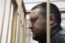 File photo of Yury Zarutsky looking out from the defendant's holding cell during a court hearing in Moscow