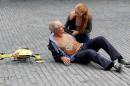 A woman gives a demonstration of an ambulance drone with built in defibrillator at the campus of the Delft Technical University in Delft on October 28, 2014.
