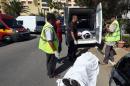 Tunisian medics load the bodies of victims into a van after a shooting in the resort town of Sousse on June 26, 2015