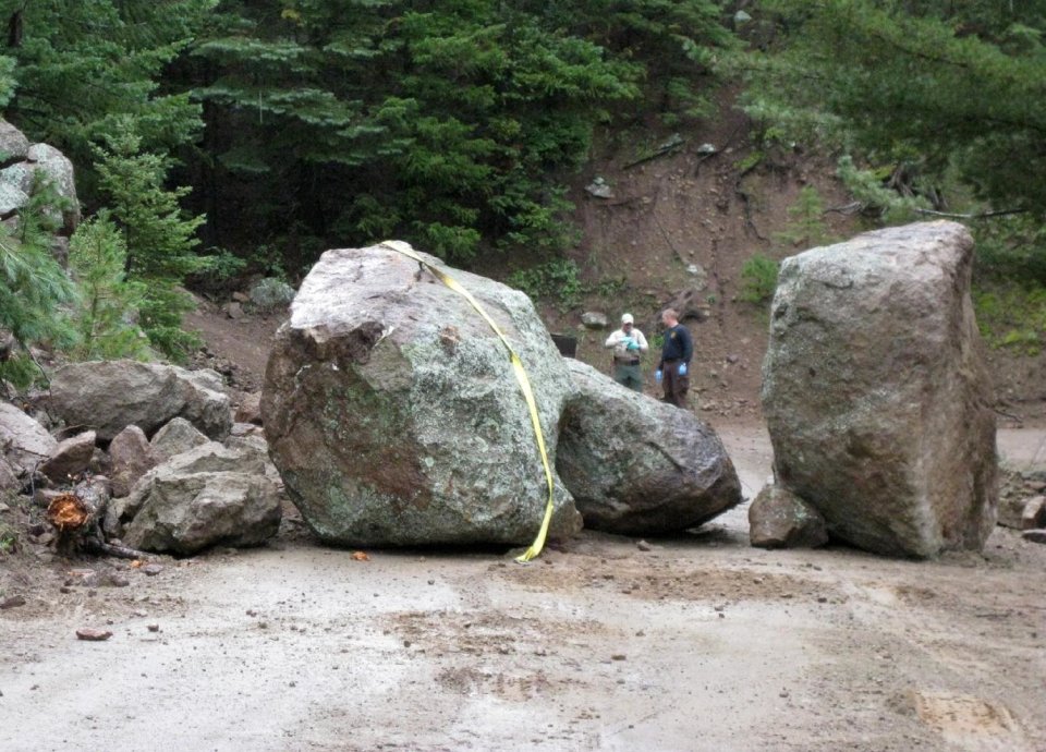 This photo released Wednesday Sept. 11, 2013 by Coconino County Sheriff's office shows investigators at the scene of a boulder slide where a Phoenix man was seriously injured while trying to move another boulder. The 27-year-old unidentified man was hospitalized for injuries to his legs and pelvis. (AP Photo/Coconino County Sheriff’s Office)