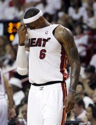 Miami Heat's LeBron James (6) wipes his face during the second half of Game 5 in their NBA basketball Eastern Conference Finals playoff series against the Boston Celtics, Tuesday, June 5, 2012, in Miami. The Celtics won 94-90. (AP Photo/Lynne Sladky)