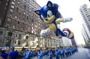 FILE - In this Nov. 22, 2012, file photo, handlers keep a tight rein on the Sonic the Hedgehog balloon as it travels the route of the Macy's Thanksgiving Day Parade in New York. Macy's says it is closely monitoring the weather after recent forecasts predicted wind gusts up to 30 mph on Thanksgiving morning during the department store's upcoming Thanksgiving Day Parade. Based on New York City guidelines, no giant balloons will be operated if the wind gusts exceed 34 mph. (AP Photo/Charles Sykes, File)