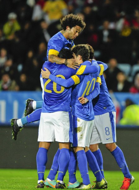 Brazil's Oscar celebrates with teammates Hulk, Marcelo and Kaka after his goal in international friendly soccer match against Iraq in Malmo