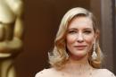 Cate Blanchett, best actress nominee for her role in "Blue Jasmine" wears a nude Armani gown with metallic embellishments as she poses at the 86th Academy Awards in Hollywood, California