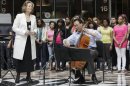 World-famous cellist Yo-Yo Ma and famed soprano Renee Fleming, left, perform with a choir of dozens of high school students in the rotunda of the State of Illinois building, the James R. Thompson Center, Monday, March 19, 2012, in Chicago. The Monday afternoon performance was to promote the Chicago Symphony Orchestra's Citizen Musician initiative. The Lyric Opera of Chicago also sponsored the event and Illinois Gov. Pat Quinn attended. (AP Photo/Kiichiro Sato)