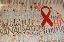 A giant painting with the image of a red ribbon is seen in central Brussels, ahead of World AIDS Day