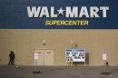 A man stands on a skateboard outside a Wal-Mart store in Williston