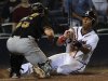 Atlanta Braves' Julio Lugo slides safely home in front of Pittsburgh Pirates catcher Michael McKenry to win the game during the 19th inning of a baseball game, Wednesday, July 27, 2011. in Atlanta. Atlanta won 4-3. (AP Photo/John Amis)