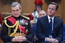 Britain's Prime Minister David Cameron (R) and General Nicholas Houghton, Chief of the Defence Staff, listen to speeches during a reception at Guildhall on March 13, 2015
