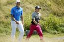 Jordan Spieth and Rory McIlroy, of Northern Ireland, smile as they walk to the fifth green during the first round of the PGA Championship golf tournament Thursday, Aug. 13, 2015, at Whistling Straits in Haven, Wis. (AP Photo/Jae Hong)