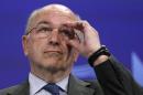 European Union Competition Commissioner Almunia adjusts his glasses during a news conference in Brussels