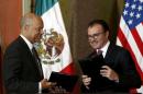 U.S. Department of Homeland Security Secretary Johnson and Mexico's Finance Minister Videgaray exchange documents after signing agreement to announce program of pre-inspection border stations during news conference in Mexico City