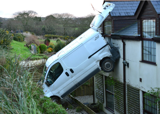 A white van man is lucky to be alive after he                        crashed his motor, flipping it and landing it                        vertically against a hotel near Newquay, Cornwall.                        Luckily no one was hurt. Simon Hill, owner of the                        White H