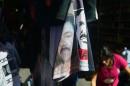 T-shirts with the portrait of Mexican drug lord Joaquin "El Chapo" Guzman are displayed for sale at Tepito neighborhood, in Mexico City on January 27, 2015