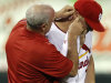 St. Louis Cardinals trainer Barry Weinberg, left, looks at the ear of Cardinals left fielder Matt Holliday during the eighth inning of a baseball game against the Los Angeles Dodgers Monday, Aug. 22, 2011, in St. Louis. Holliday left the game holding his ear. (AP Photo/Jeff Roberson)
