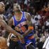 Miami Heat's Ray Allen fouls New York Knicks' J.R. Smith as the Heat's LeBron James looks on in the send half of their NBA basketball game in Miami, Florida