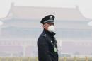 A policeman, wearing a mask to protect from severe pollution, secures the area near the Great Hall of the People before the opening session of the Chinese People's Political Consultative Conference (CPPCC) in Beijing