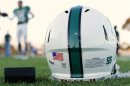 A football helmet's health warning sticker is pictured as high school football team prepares for night game in Oceanside