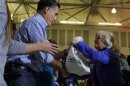 U.S. Republican presidential nominee Romney accepts relief supplies for people affected by Hurricane Sandy in Kettering