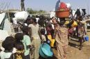 Civilians arrive to a shelter at the United Nations Mission in the Republic of South Sudan compound on the outskirts of capital Juba in South Sudan