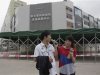 Foxconn employees eat ice creams during lunch break in front of the Foxconn recruitment center in Shenzhen