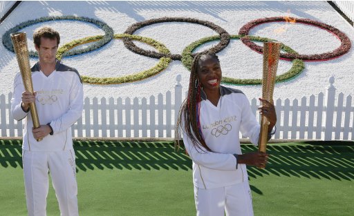 Britain's Andy Murray and Venus Williams of the U.S. pose with the Olympic Torch on Murray Mound at the All England Lawn Tennis Club before the start of the London 2012 Olympic Games in London