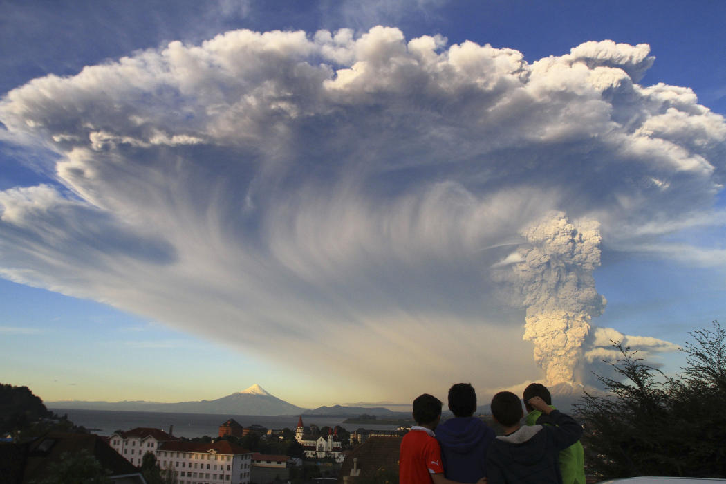 Children watch the Calbuco volcano erupt, from Puerto Varas, Chile, Wednesday, April 22, 2015. The volcano erupted billowing a huge ash cloud over a...