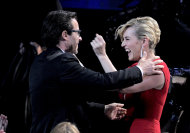 Guy Pearce, left, is seen with costar Kate Winslet before accepting the award for outstanding supporting actor in a miniseries or a movie for “Mildred Pierce” at the 63rd Primetime Emmy Awards on Sunday, Sept. 18, 2011 in Los Angeles. (AP Photo/Mark J. Terrill)
