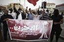 Bahraini protesters hold a banner reading, "Bahrain, a revolution of the people that refuse to be silent", during a demonstration to mark the fourth anniversary of the Arab Spring-inspired uprising on February 14, 2015, in the village of Daih