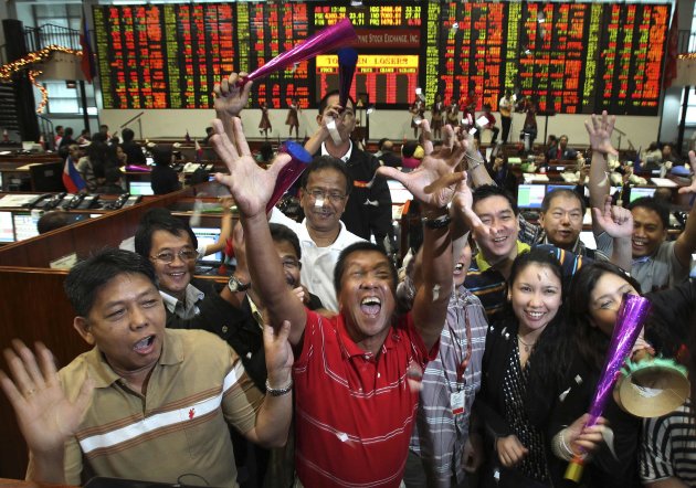 Traders throw confetti as they celebrate the last trading day of the year at the Philippine Stock Exchange in Makati, the financial district of Manila, in this December 29, 2011 file photo. Asia's top companies are less upbeat on their business outlook than in the first quarter, with mounting concern over the euro zone crisis and a slowdown in China's growth, according to the latest Thomson Reuters/INSEAD Asia Business Sentiment Survey, published on June 20, 2012. To match story ASIA-COMPANIES-SENTIMENT/    REUTERS/Romeo Ranoco/Files (PHILIPPINES - Tags: BUSINESS)