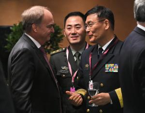 Head of Chinese delegation, Admiral Sun Jianguo (R), …