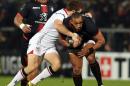 Toulouse's French centre Gael Fickou (R) is tackled during the European Rugby Champions Cup pool rugby union match between Ulster Rugby and Stade Toulousain at the Kingspan Stadium in Belfast, Northern Ireland, on December 11, 2015
