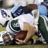 New York Jets quarterback Tim Tebow (15) is sacked for a 2-yard loss by Tennessee Titans linebacker Zach Brown (55) in the second quarter of an NFL football game, Monday, Dec. 17, 2012, in Nashville, Tenn. (AP Photo/Wade Payne)