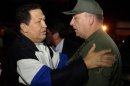 In this photo released by Miraflores Press Office, Venezuela's President Hugo Chavez, left, speaks with his Defense Minister Diego Molero upon his arrival to Simon Bolivar airport in Maiquetia, near Caracas. Venezuela, Friday, Dec. 7, 2012. Chavez arrived back home in Caracas after 10 days of medical treatment in Cuba. (AP Photo/Miraflores Press Office, Marcelo Garcia)