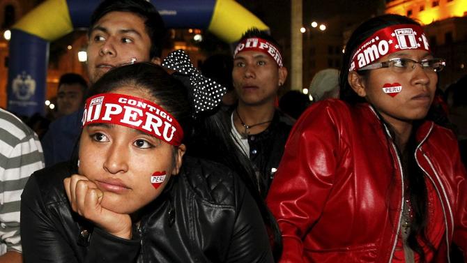 Peruvian fans watch the Copa America semi-final soccer match between Peru and Chile played in Santiago, Chile, at the Main square in down town Lima