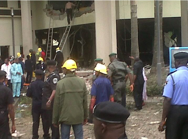 This image released by Saharareporters shows firefighters and rescue workers after a large explosion struck the United Nations' main office in Nigeria's capital Abuja Friday Aug. 26, 2011, flattening 