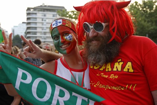 Soccer fans dressed in Portugal's and Spain's colors pose before their semi final Euro 2012 soccer match between the Portugal and Spain at a public screening in Lisbon