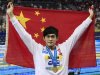 China's Sun Yang raises his national flag after winning the gold medal in the men's 800 m Freestyle at the FINA 2011 Swimming World Championships in Shanghai, China, Wednesday, July 27, 2011. (AP Photo/Eugene Hoshiko)
