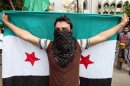 Supporter of an Islamic group, holds up a Syrian revolution flag, as he march during a demonstration against the Syrian regime, after Friday prayers, in Beirut, Lebanon, Friday, April 20, 2012. The United Nations hopes to have 30 cease-fire monitors in Syria next week and plans are already being made for the deployment of up to 300, a spokesman for international envoy Kofi Annan said Friday. (AP Photo/Bilal Hussein)