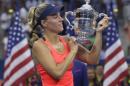 Angelique Kerber, of Germany, holds up the championship trophy after beating Karolina Pliskova, of the Czech Republic, to win the women's singles final of the U.S. Open tennis tournament, Saturday, Sept. 10, 2016, in New York. (AP Photo/Darron Cummings)