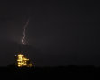 Lightning flashes in the sky above space shuttle Endeavour at the Kennedy Space Center at Cape Canaveral, Fla., on Thursday, April 28, 2011.  Endeavour is scheduled to launch Friday afternoon on its l