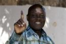 Presidential candidate Jose Mario Vaz shows his inked finger after voting in Bissau