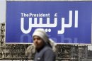 Man walks past a banner publicising the presidential election in Cairo