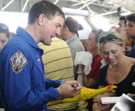 NASA astronaut Rex Walheim signs an autograph at the welcome home ceremony for the astronauts of the final shuttle mission Friday, July 22, 2011, in Houston. (AP Photo/Pat Sullivan)