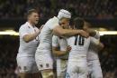 England's Jonathan Joseph, center, celebrates with teammates after scoring against Wales during their 6 Nations Championship Rugby match at the Millennium Stadium, Cardiff, Friday Feb. 6, 2015. (AP Photo/Jon Super)