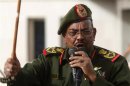 Sudanese President Omar Hassan al-Bashir addresses supporters after receiving victory greetings at the Defence Ministry, in Khartoum
