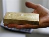 Gold dealer Stan Morton holds a block of gold valued at $63,000 in Los Angeles