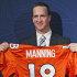 New Denver Broncos quarterback Peyton Manning holds a Broncos jersey with his name and number at the conclusion of an NFL football news conference at the Broncos headquarters in Englewood, Colo.,  on Tuesday, March 20, 2012.  (AP Photo/Ed Andrieski)