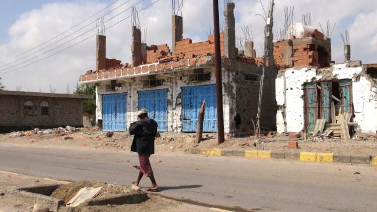 A Yemeni man walks past destroyed buildings in Zinjibar, capital of Abyan province in southern Yemen on December 5, 2012